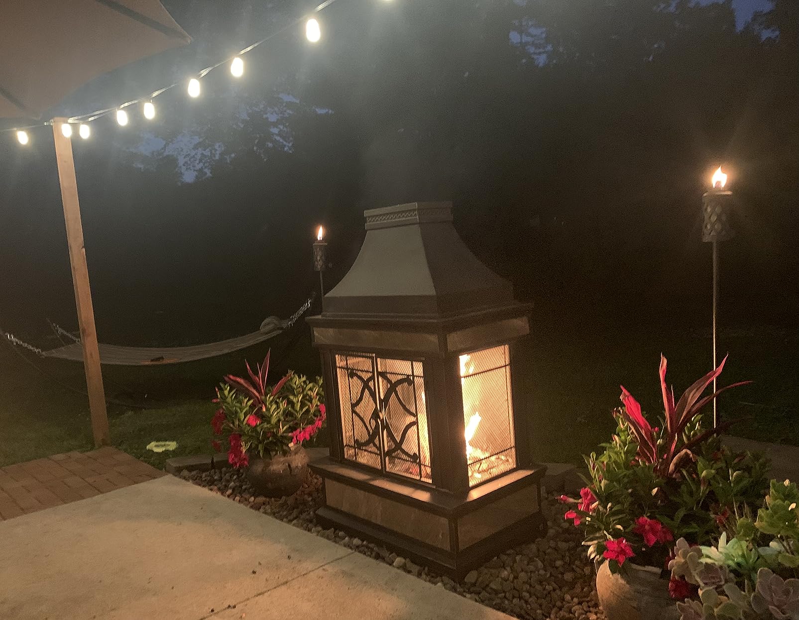 Sunjoy Outdoor Fireplace, Stone Look Tile Patio Wood Burning Steel Fireplace with Chimney, Spark Screen, Fire Poker, Rain Cover, and Removable Grate, Black with Golden Highlight customer photo 1
